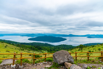 Lake Kussharo in summer season sunny day. Natural landscape from Bihoro-toge pass lookout view...