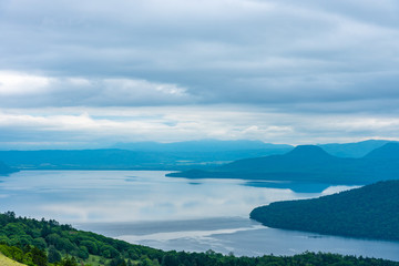 Fototapeta na wymiar Lake Kussharo in summer season sunny day. Natural landscape from Bihoro-toge pass lookout view point. Akan Mashu National Park, Hokkaido, Japan