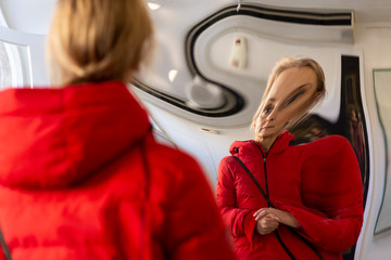 woman distorted in a mirror