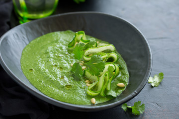 Green cold spinach and cucumber soup. Selective focus.