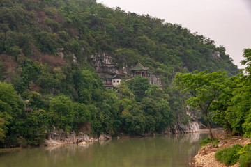 Fototapeta na wymiar Landscape, Traditional buildings on slope along Xiadong, Guilin, China.