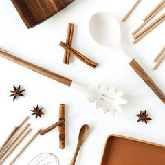 Kitchenware on white background. Organic food preparation concept. Flat lay, top view tan color...