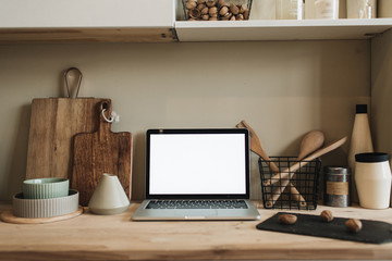 Kitchen workspace with blank copy space mock up laptop screen. Modern stylish kitchen interior...