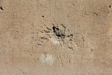 Holes on the wall from shells, bullets.