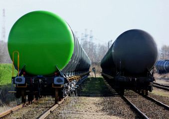 green freight train tankers in railroad station for ethanol shipping. soft blurred industrial background. diminishing perspective. bio fuel tanker railroad cars. rail transport concept.