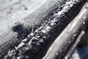 snow crystals on picket fence