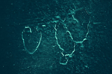 Vintage azure background. Rough painted wall of turquoise color. Imperfect plane of cyan colored. Uneven old decorative toned backdrop of aqzure tint. Texture of teal hue. Ornamental stony surface.