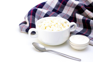 Breakfast concept. cottage cheese, sour cream on a light background and a towel. white