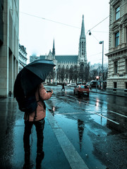 A man with umbrella in a raining street background