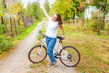 Young woman riding bicycle in summer city park outdoors. Active people. Hipster girl relax and...