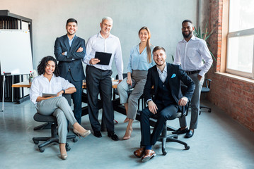 Group Of Successful Business People Posing At Workplace In Office