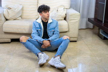 Young man posing on a living room sofa