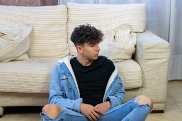 Young man posing on a living room sofa