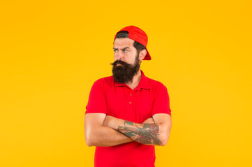 Cool and free man. Serious man yellow background. Bearded man keep hands crossed with confidence. Caucasian man with mustache and beard hair. Barbershop. Fashion and style. Hipster lifestyle