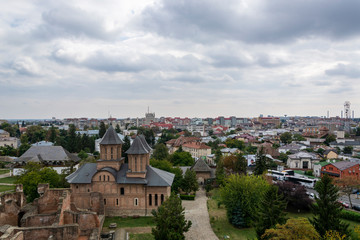 Târgoviște, Romania - 10/08/2019: Târgoviște castle, tower. Vlad the Impaler, Dracula's old capital. View to the city. Cloudy sky. Romania