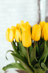 Bunch of yellow tulips on the table