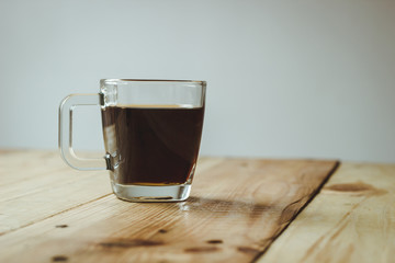 cup of coffee on wooden table on white background