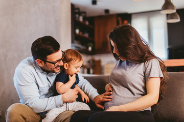 Happy family at home excited about expecting new baby - 330834681