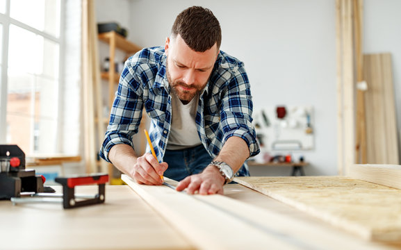 young male carpenter working in  workshop.