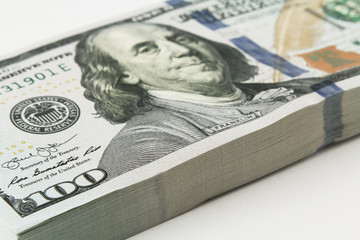 Stack of american money, one hundred dollar cash banknotes on white background, lot of one hundred...