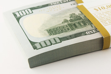 Stack of american money, one hundred dollar cash banknotes on white background, lot of one hundred dollar bills