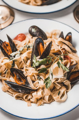Pasta with mussels and herbs, restaurant dish
