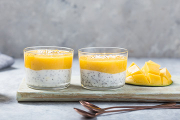 Chia seed pudding with mango in glass jars. Clean eating, healthy vegan vegetarian food concept