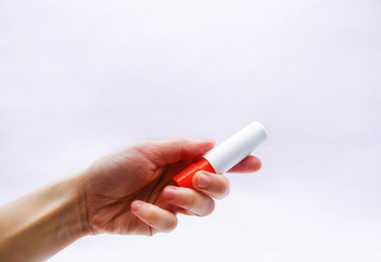 tube with hygienic lipstick in hand