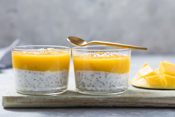 Chia seed pudding with mango in glass jars. Clean eating, healthy vegan vegetarian food concept