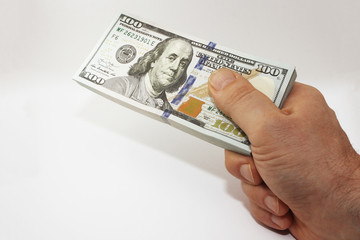 Stack of american money in hand, one hundred dollar cash banknotes on white background, lot of one hundred dollar bills