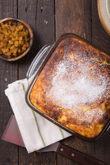 Cottage cheese casserole with raisins on top. Flat lay, top view.
