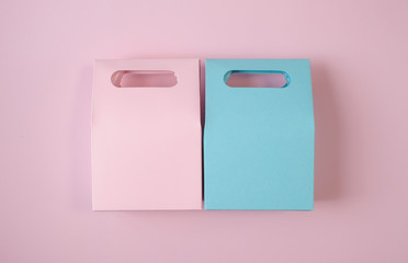 Blue and pink gift bags on pink background