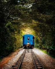  Young man with backpack misses train in the middle of nature