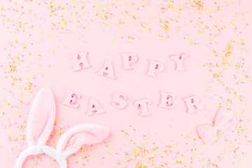 Happy Easter Greeting card with the inscription on a pink paper background.Concept of festive greeting