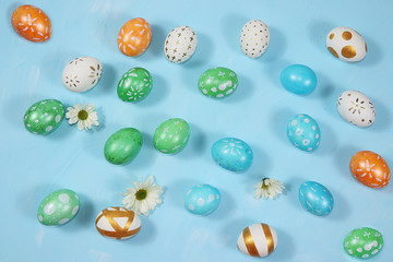 Decorated golden and green eggs on a trendy blue background. Minimal holiday concept. Happy Easter...