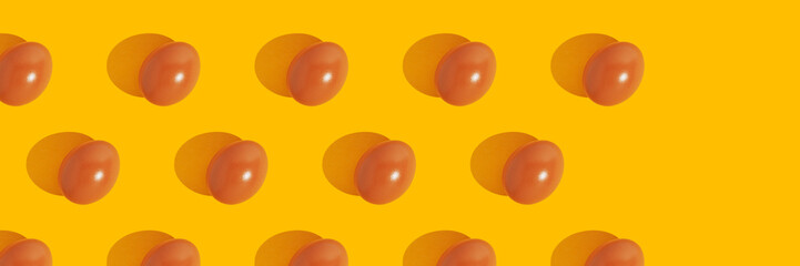 Modern minimalistic easter pattern. Brown eggs on yellow background.