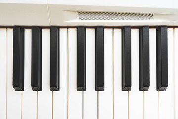 Naklejka premium keys on a white piano close -up, tinted image, selective focus