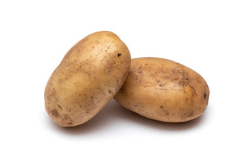 two raw dirty potatoes on a white background
