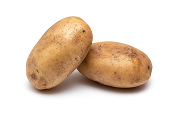 two raw dirty potatoes on a white background