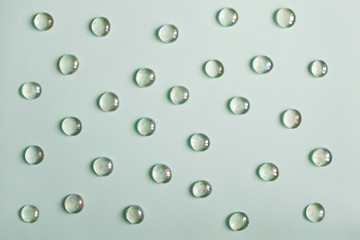 Glass imitating water drops on green background