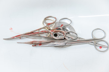 Surgical instruments with traces of blood in a sink for cleaning after surgery