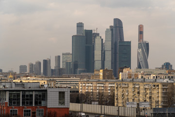 Skyscrapers in Moscow among low-rise buildings, spring afternoon