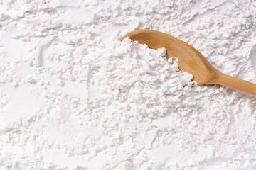 Background of corn starch flour powder texture close-up.