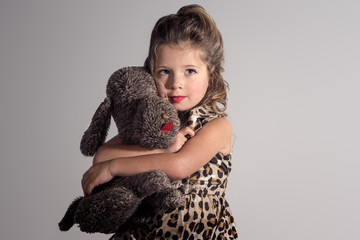 Little girl with big eyes and a bear. 