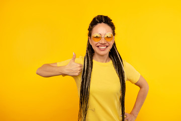 Happy attractive smiling lady isoated in yellow room