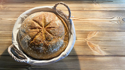 Homemade sourdough bread, on a wooden background, ..is fresh and still warm............