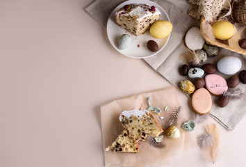 Fototapeta na wymiar Beautiful Easter composition of eggs with natural colors, gingerbread, flowers, feathers. Flat lay