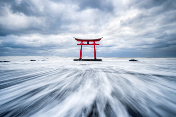 Red torii gate in the sea near Shosanbetsu