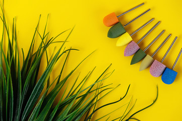 Set of cutters for manicure and pedicure on a yellow background