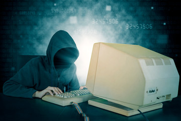 Hacker typing on keyboard with binary code background
